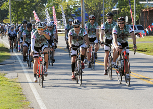 Maj. Gen. Mark Clark rides with Operations One Voice cyclists.