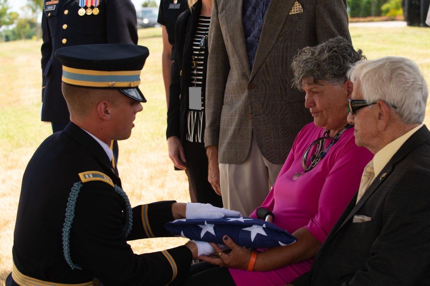 Goia Palmerio receives the American flag during the funeral for her father, Caesar Civitella, a special operations icon, at Arli