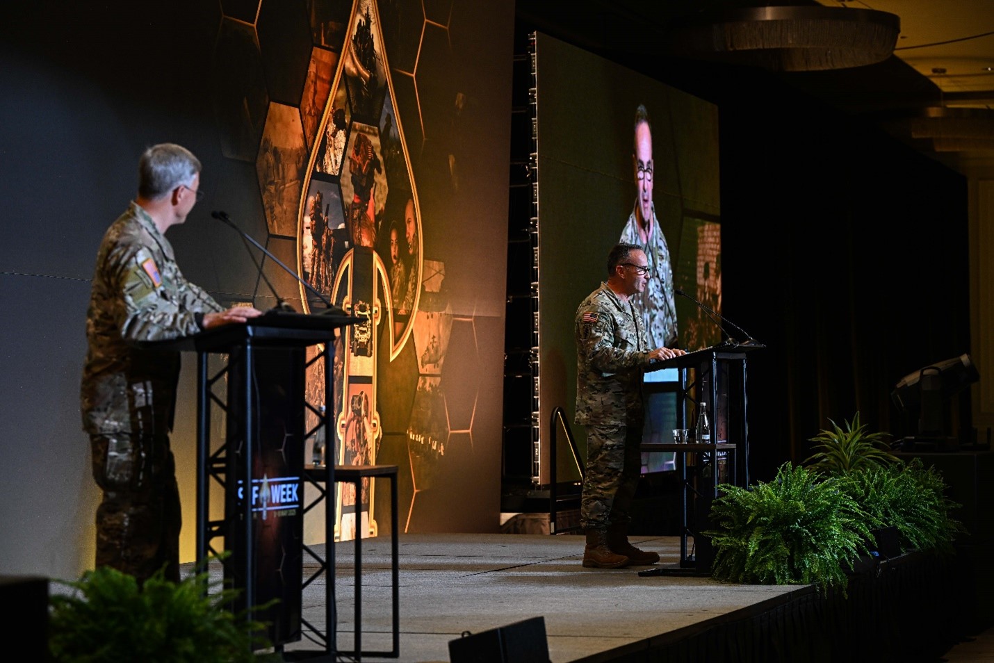Two men speaking on a stage.