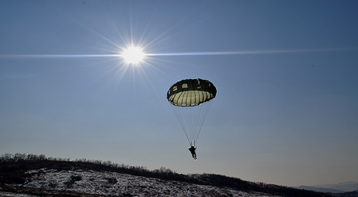 Photo of a paratrooper parachutting.